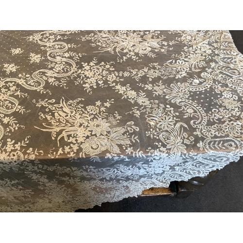 104 - An early 20th century Brussels bobbin lace wedding veil and later Carrickmacross lace stole. The vei... 