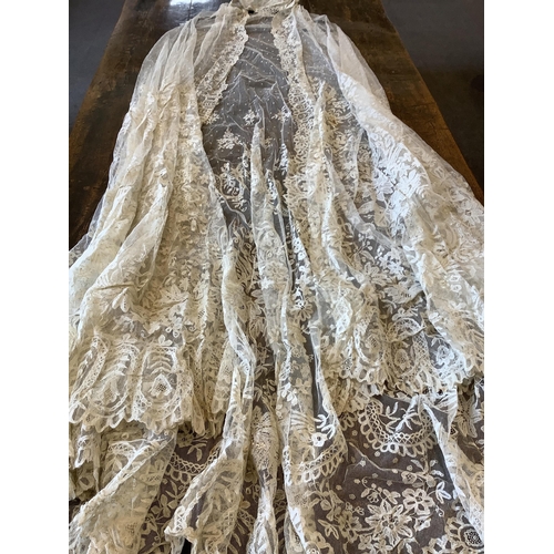 104 - An early 20th century Brussels bobbin lace wedding veil and later Carrickmacross lace stole. The vei... 
