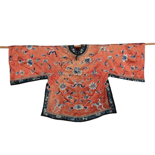 108 - A late 19th century Chinese coral silk robe embroidered with bats and flowers in blues and gold thre... 