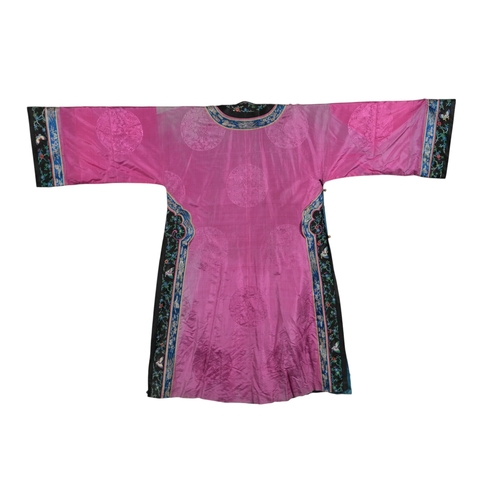 111 - An early 20th century Chinese full length fuchsia coloured silk damask robe, with polychrome embroid... 