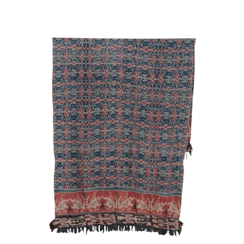 119 - An early 20th century Indonesian Sumba, hand woven and hand dyed in two narrow loom panels, in a blu... 