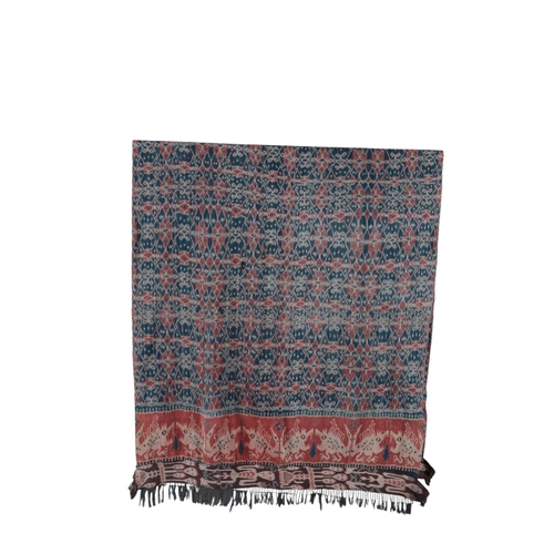 119 - An early 20th century Indonesian Sumba, hand woven and hand dyed in two narrow loom panels, in a blu... 