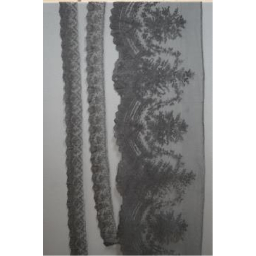 61 - A black silk flounce of wide Chantilly lace trimming and two similar narrower Chantilly trimmings, t... 
