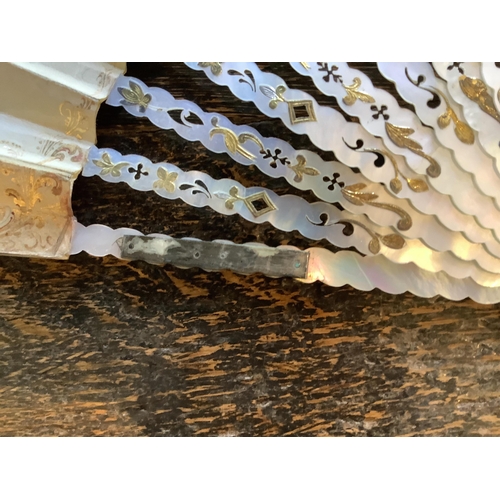 68 - A mother of pearl and sequin fan, another with painted figural leaf in a E T Piver, Paris box, a Caf... 