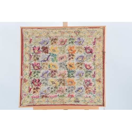 72 - A framed late 19th century silk floral embroidery on brown and red woven background, embroidered wit... 