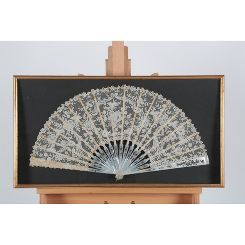 76 - Two 19th century mother of pearl Brussels lace fans framed and glazed. One with a central Point de G... 