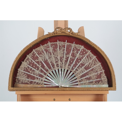 76 - Two 19th century mother of pearl Brussels lace fans framed and glazed. One with a central Point de G... 