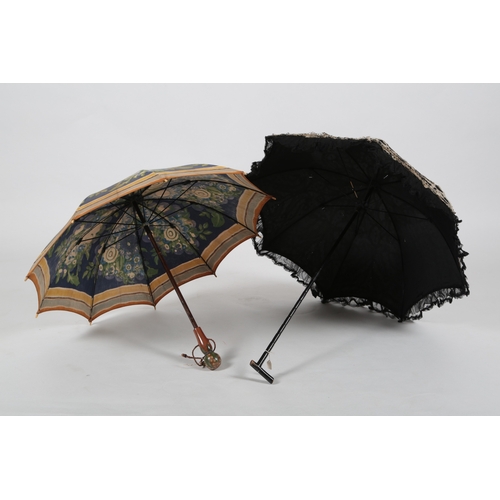 86 - An Edwardian black silk chiffon parasol, ornately appliquéd with cream silk ribboning, 92cm long, to... 