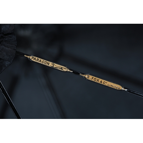 86 - An Edwardian black silk chiffon parasol, ornately appliquéd with cream silk ribboning, 92cm long, to... 