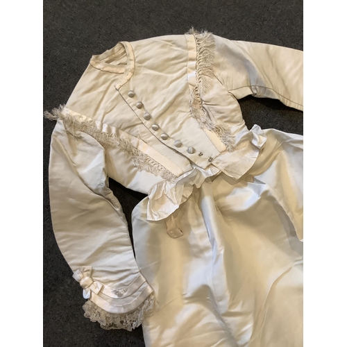 96 - A rare 1860s cream silk grosgrain wedding dress, with bustle apron, a bow attachment and floral waxe... 