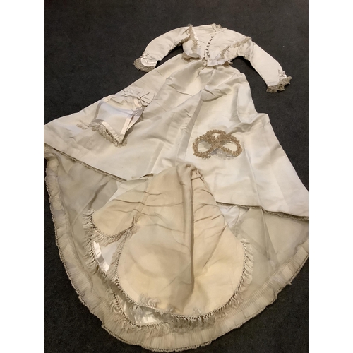 96 - A rare 1860s cream silk grosgrain wedding dress, with bustle apron, a bow attachment and floral waxe... 