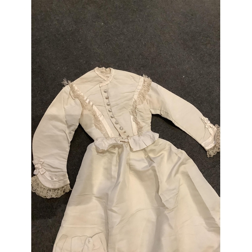 96 - A rare 1860s cream silk grosgrain wedding dress, with bustle apron, a bow attachment and floral waxe... 