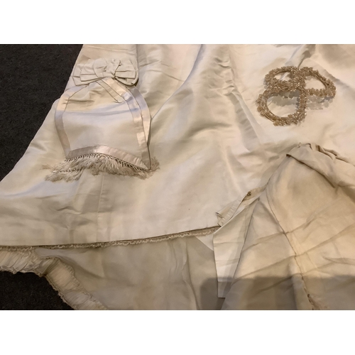 96 - A rare 1860s cream silk grosgrain wedding dress, with bustle apron, a bow attachment and floral waxe... 