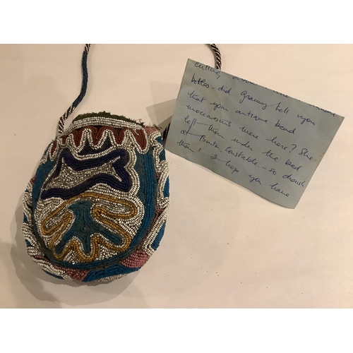 99 - A 19th century Native North American, Iroquois horseshoe shaped multi-coloured beaded purse with cen... 