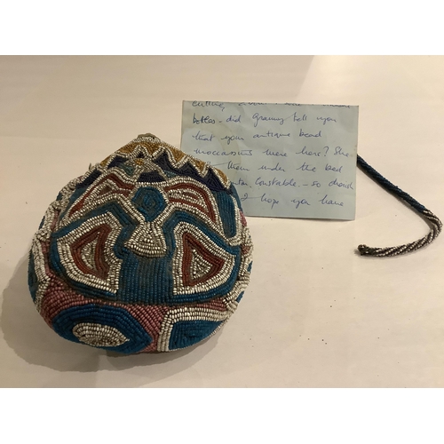 99 - A 19th century Native North American, Iroquois horseshoe shaped multi-coloured beaded purse with cen... 