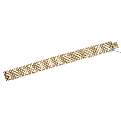 221 - A gold bracelet, late 19th century, the articulated strap composed of brick linking, length 18cm, ma... 