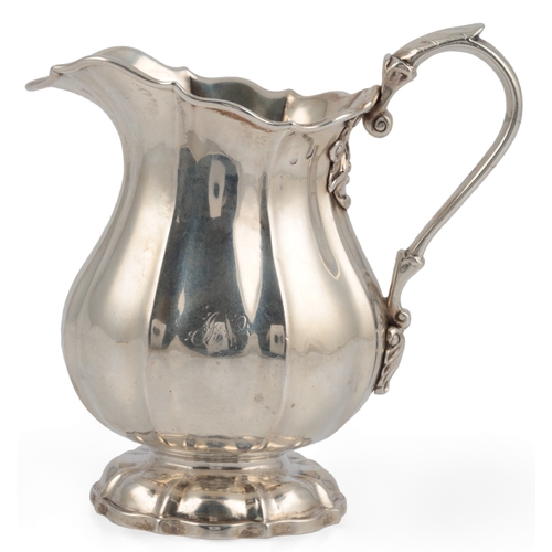 38 - A George IV Irish silver cream jug, Dublin, 1825, of lobed baluster form, with engraved crest, indis... 