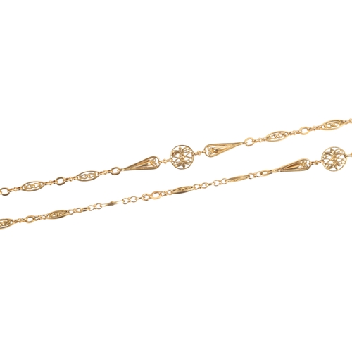 590 - An attractive gold longchain, early 20th century, composed of floral medallion, pear-shaped and oval... 