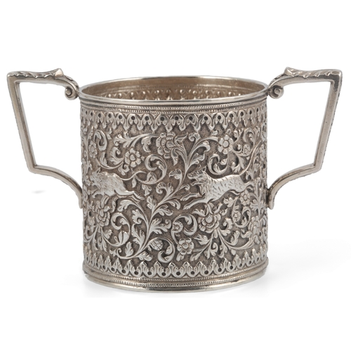 60 - A late 19th century Indian white metal three piece tea set, in the manner of Oomersee Mawjee, Bhuj, ... 