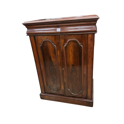 2082 - A mid Victorian rosewood press cupboard, with sliding trays, enclosed by a pair of doors, width 84cm... 