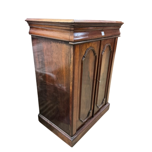 2082 - A mid Victorian rosewood press cupboard, with sliding trays, enclosed by a pair of doors, width 84cm... 