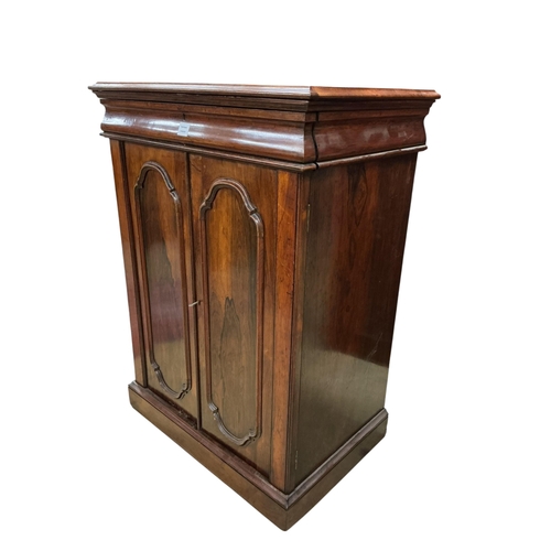 2082 - A mid Victorian rosewood press cupboard, with sliding trays, enclosed by a pair of doors, width 84cm... 