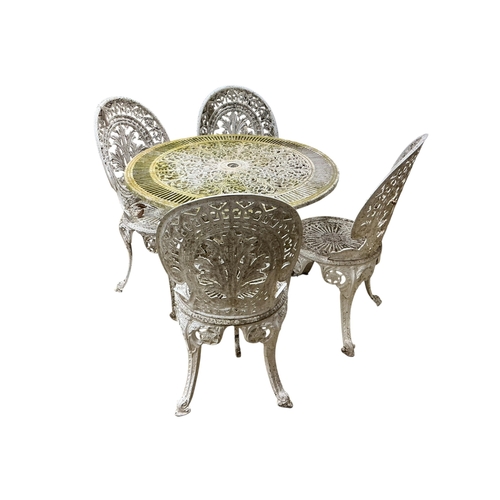 2100 - A Victorian style circular aluminium garden table, diameter 80cm, height 70cm and four chairs