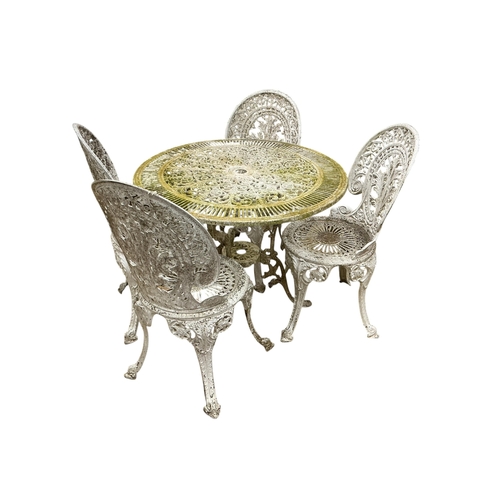 2100 - A Victorian style circular aluminium garden table, diameter 80cm, height 70cm and four chairs