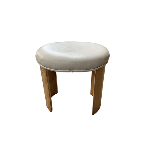 2102 - A British Art Deco oval stool, the upholstered padded seat raised on twin curved supports, c.1930, w... 