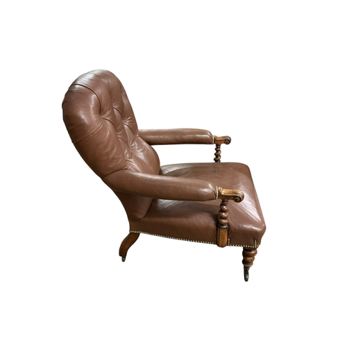 2103 - A Victorian walnut and leather upholstered library armchair with barley twist supports and legs, wid... 