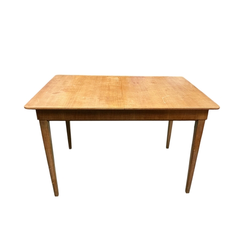 2105 - A Gordon Russell extending dining table, 135cm extended, width 78cm height 76cm and four chairs... 