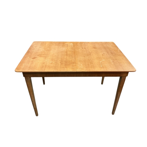 2105 - A Gordon Russell extending dining table, 135cm extended, width 78cm height 76cm and four chairs... 