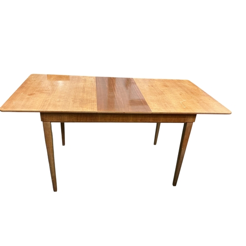 2105 - A Gordon Russell extending dining table, 135cm extended, width 78cm height 76cm and four chairs... 