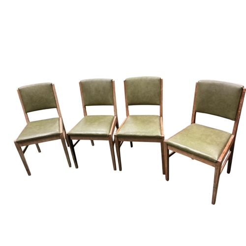 2105 - A Gordon Russell extending dining table, 135cm extended, width 78cm height 76cm and four chairs... 