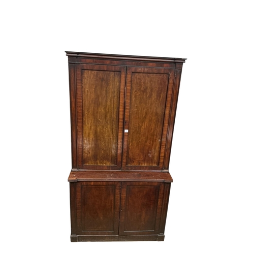2110 - A Regency mahogany bookcase, in two sections, each enclosed by a pair of panelled doors, width 128cm... 