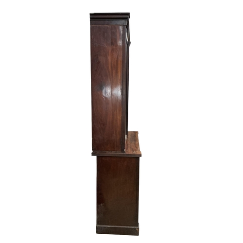 2110 - A Regency mahogany bookcase, in two sections, each enclosed by a pair of panelled doors, width 128cm... 