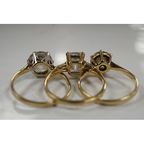 2993 - Three simulant diamond rings, comprising: a ring set with a step-cut simulant diamond with baguette ... 