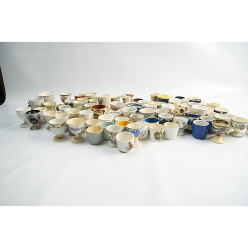 63 - A Collection of Miscellaneous Glazed Ceramic, Porcelain, and Earthenware Egg CupsA large and varie... 