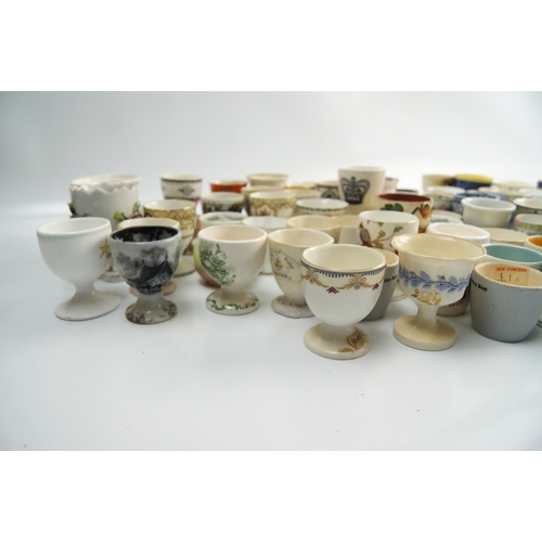 63 - A Collection of Miscellaneous Glazed Ceramic, Porcelain, and Earthenware Egg CupsA large and varie... 