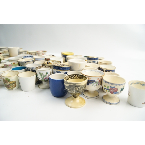 63 - A Collection of Miscellaneous Glazed Ceramic, Porcelain, and Earthenware Egg CupsA large and varie... 