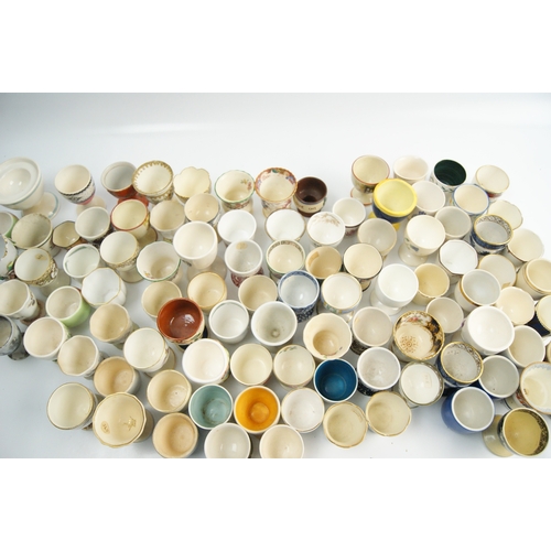 63 - A Collection of Miscellaneous Glazed Ceramic, Porcelain, and Earthenware Egg CupsA large and varie... 
