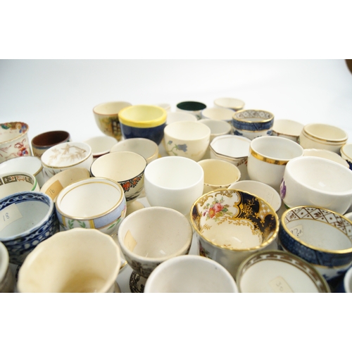 63 - A Collection of Miscellaneous Glazed Ceramic, Porcelain, and Earthenware Egg CupsA large and varie... 