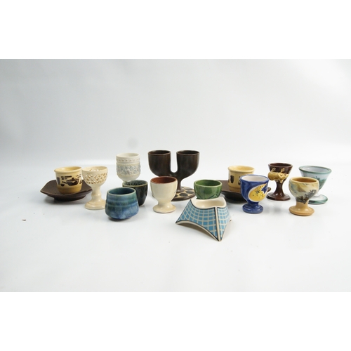 64 - A Collection of Ceramic and Porcelain Egg Cups including a Troika Double Egg CupA collection of ce... 