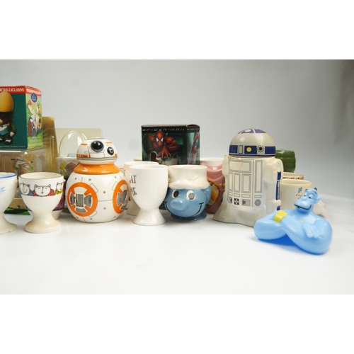 67 - A Collection of Novelty and Character-Themed Ceramic Egg CupsA varied collection of ceramic egg cu... 