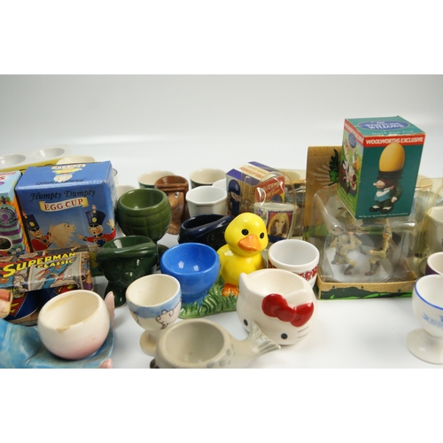 67 - A Collection of Novelty and Character-Themed Ceramic Egg CupsA varied collection of ceramic egg cu... 