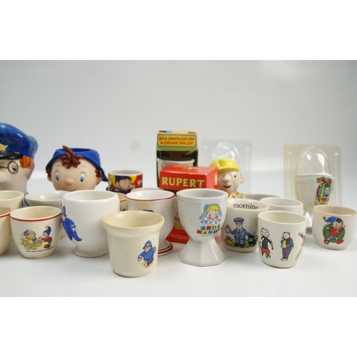 70 - A collection of vintage and contemporary character-themed ceramic egg cupsA collection of ceramic ... 