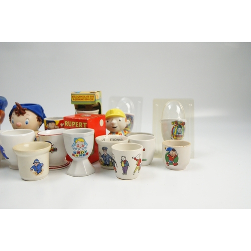 70 - A collection of vintage and contemporary character-themed ceramic egg cupsA collection of ceramic ... 