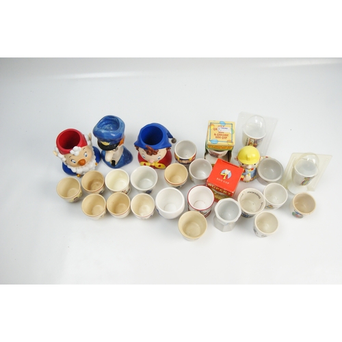 70 - A collection of vintage and contemporary character-themed ceramic egg cupsA collection of ceramic ... 