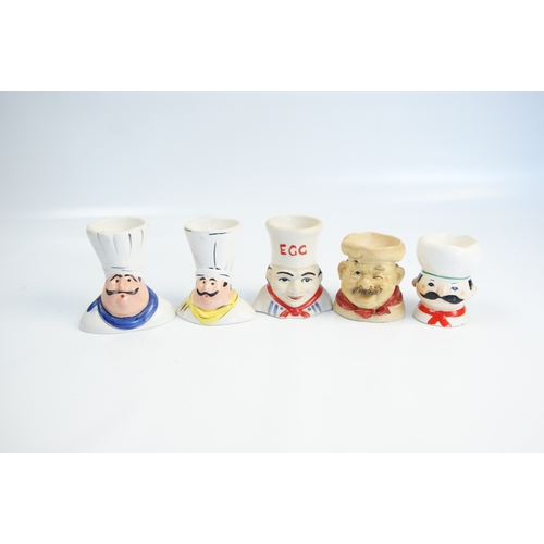 76 - A Collection of Vintage Novelty Ceramic Chef Egg CupsA collection of novelty ceramic egg cups, eac... 
