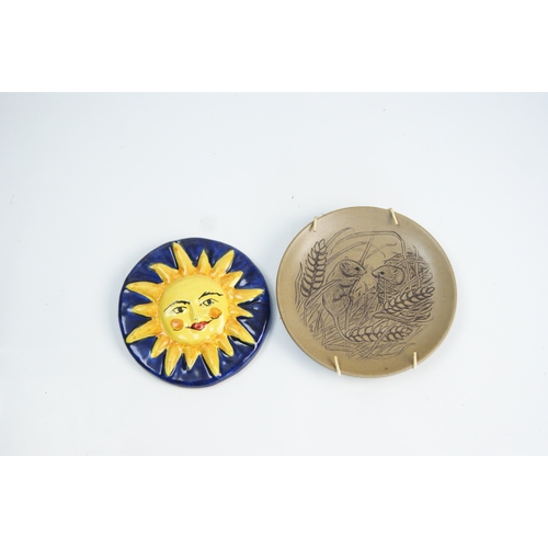 80 - Two Decorative Ceramic Items comprising a Sun Face Wall Plaque and an Incised Stoneware PlateA gro... 
